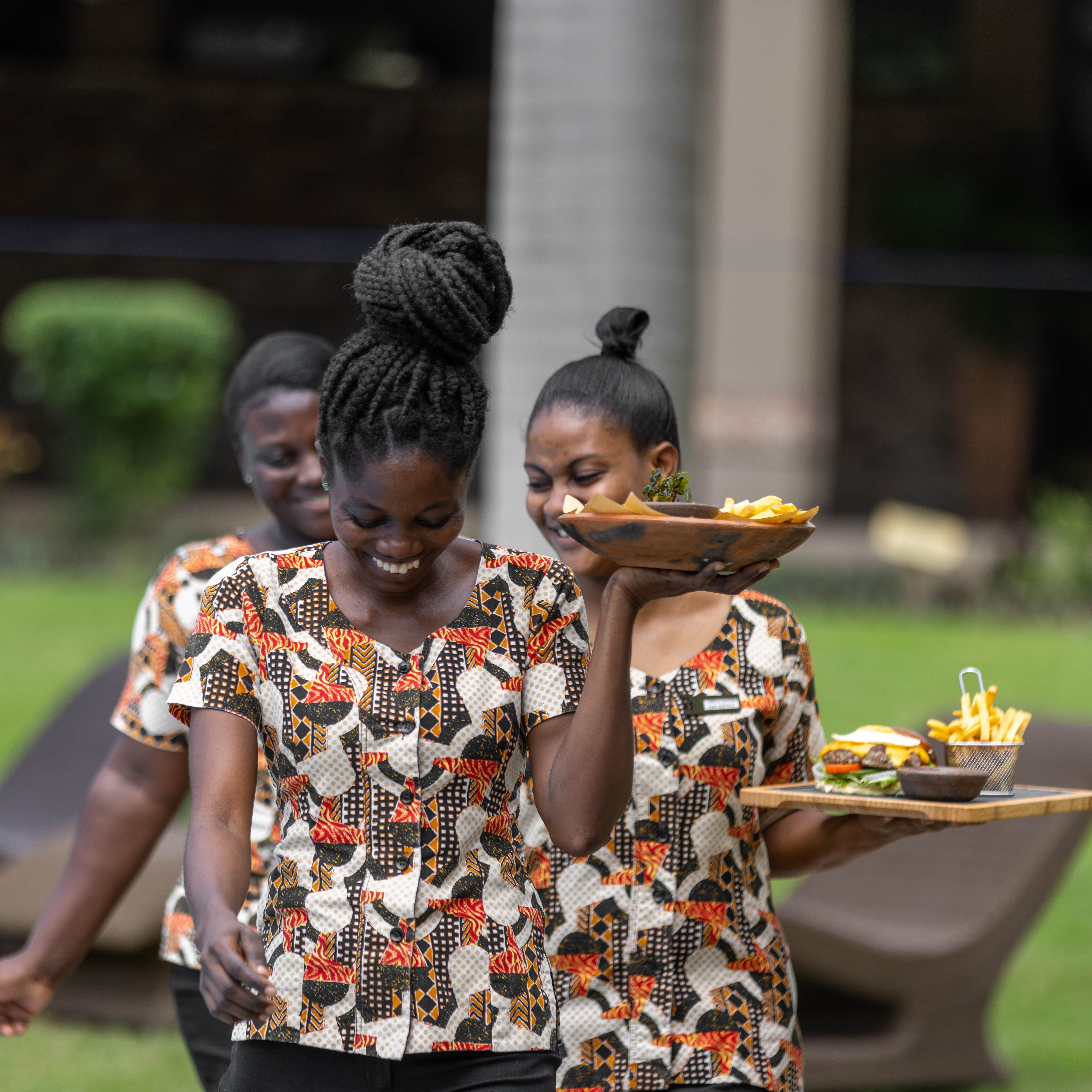 An image of the wonderful waitresses bringing an array of delicious continental food at The NSU Bar at The Royal Senchi Hotel & Resort in Ghana